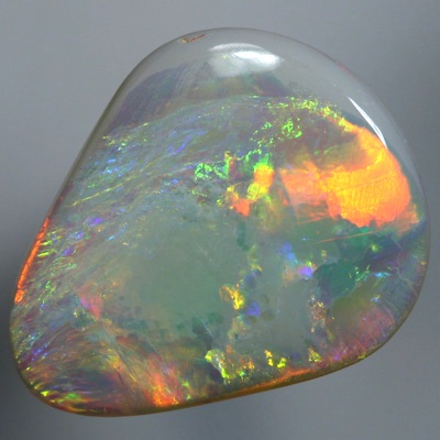 SOLID SEMI BLACK OPAL Large opal with rolling flasehs of orange SEE VIDEO